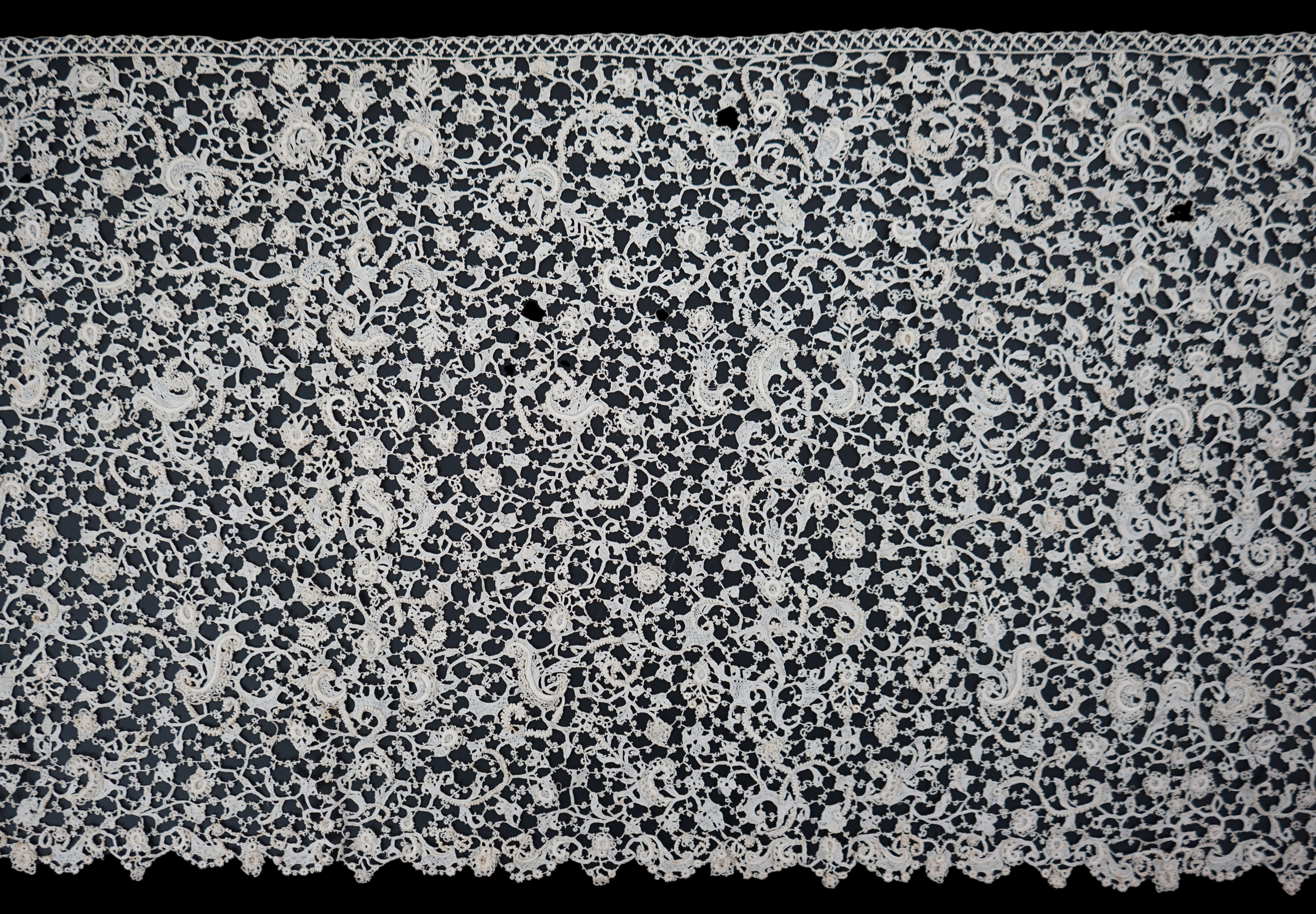 A rare 1680 (360cm length x 28cm deep) flounce of Point de neige, being an elaborate finely raised Venetian needle-point lace, a scaled down version of gros point, this flounce worked into tiny floral and leaf shapes, jo